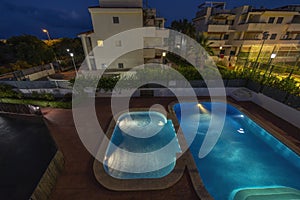 illuminated swimming pools at night