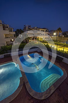 illuminated swimming pools at night