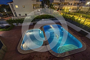 illuminated swimming pools at night