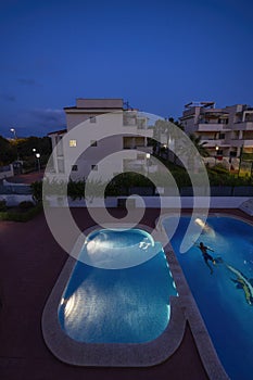 illuminated swimming pools at night