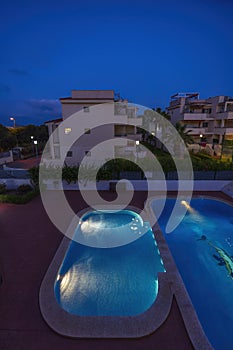illuminated swimming pools at night