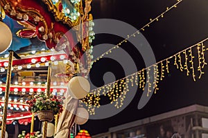 Illuminated swing chain carousel in amusement park at night