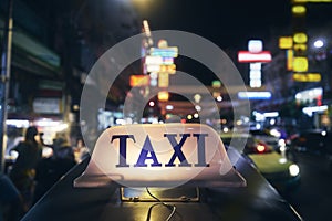 Illuminated taxi sign on roof of tuk tuk