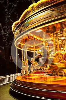 An illuminated temporary carousel for Christmas at night