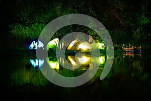 Illuminated tent on a lake with reflexions