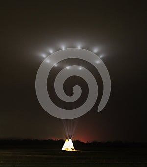 Illuminated Tipi, Teepee, at night Projecting Light into the Sky photo
