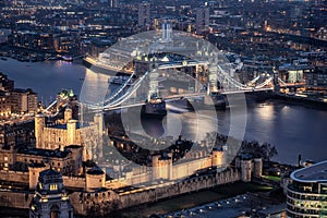 The illuminated Tower and the Tower Bridge of London by night photo