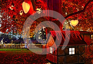 Illuminated tree with heart shaped lights and little house on Christmas markets in Vienna