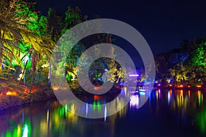 Illuminated trees and lake, Pukekura Park, New Plymouth, New Zealand photo