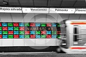 Illuminated underground metro station, public transport in Prague, Czech Republic, departing train from the station photo