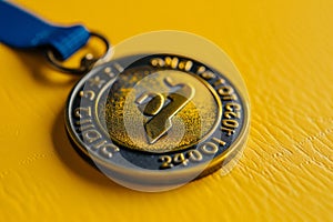 Illuminated Victory A Boston Marathon Medal Shines on Yellow