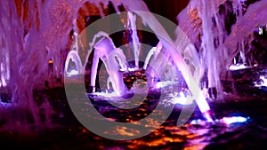 Illuminated water in city fountain at night