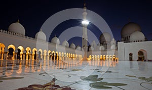 Illuminated White Marble Zayed Grand Mosque in Abu Dhabi Against Dark Blue Sky
