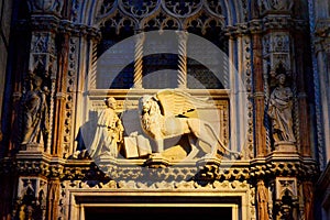 Illuminated The winged lion and the doge Francesco Foscari on the Doge Palace in Venice, Italy