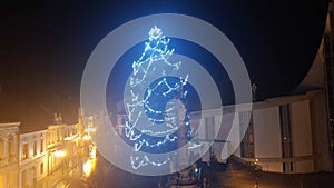 Illuminated Xmas tree during a severe wind storm. Lighted Christmas tree during a strong wind gale