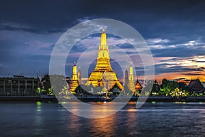 Illumination of Grand Pagoda of Wat Arun Ratchawararam Temple at Sunset, Bangkok, Thailand