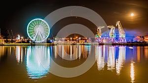 Illuminations in the Polish city of Szczecin, ferris wheel, port grider,  at night Europa