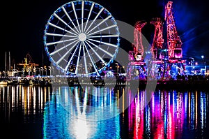 Illuminations in the Polish city of Szczecin, ferris wheel, port grider,  at night Europa