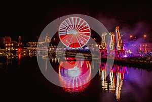 Illuminations in the Polish city of Szczecin, ferris wheel, port grider,  at night Europa