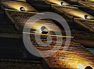 Illuminators on brick wall photo