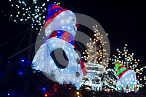 Illumined snowman in the christmas decorative background