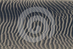 Illusion patterns on sandy beach. photo