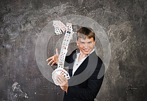 Illusionist man with fountain of cards