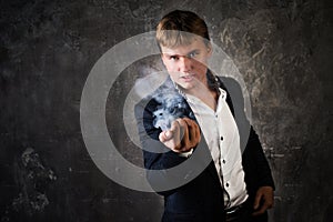 Illusionist man makes smoke his hand