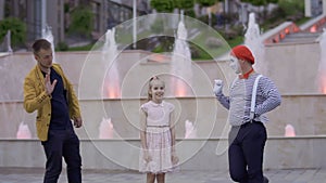 Illusionist and mime try to pay girl`s attention on himself