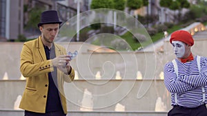 Illusionist throws playing cards into mime