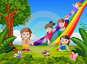 Cartoon kids sliding down the rainbow