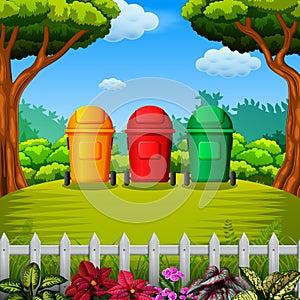 The colorfull trashbin with the garden view photo