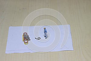 Illustration, different perspective makes another value, sitting at paperclip and standing businessman mini figure toys facing