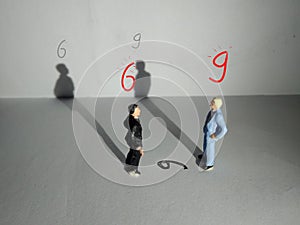 Illustration, different perspective makes another value, standing businessman mini figure toys facing number six or nine photo