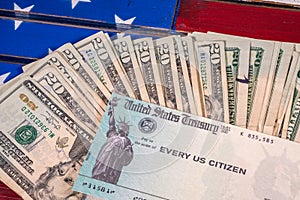 Illustration of the federal stimulus payment check with stack of cash on US Flag