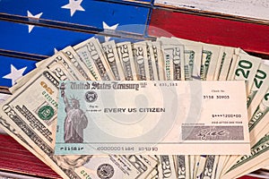 Illustration of the federal stimulus payment check with stack of cash on US Flag