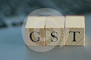 Illustration GST written on wooden blocks