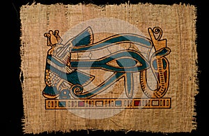 Horus ancient eye on papyrus paper photo