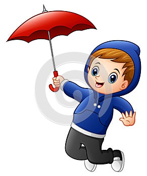 Little boy with red umbrella jumping