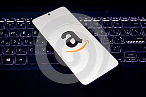 Illustration photo of close-up Amazon logo displayed on a screen of smartphone