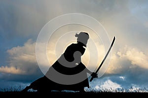 Samurai with sword at sunset