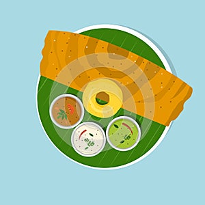 South Indian breakfast dish `Dosa and Vada with Sambar and Chutney` on banana leaf