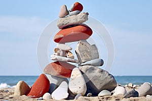 Stack of zen stones on the beach with sea in the background