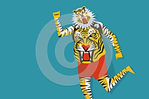 A man with body painted with tiger stripes dancing during the festival of Onam in Kerala, Indi photo