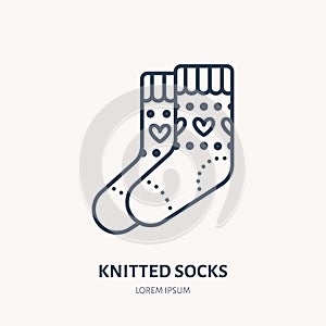 Illustration of woolen socks. Knitted clothing shop line logo. Vector flat sign for atelier or garment shop