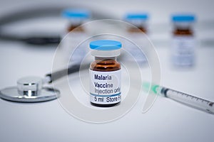 Illustrative picture of malaria vaccine vial with syringe and stethoscope