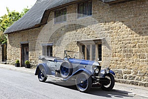 ILMINSTER, SOMERSET, ENGLAND - JUNE 6, 2018: Classic Blue Morris Oxford motor car outside a country cottage