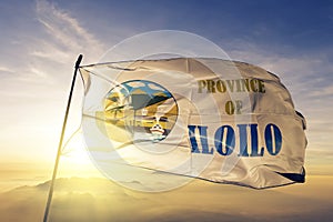 Iloilo province of Philippines flag textile cloth fabric waving on the top sunrise mist fog