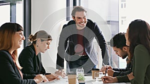 Im all ears to your ideas. a young businessman giving a presentation to his colleagues in an office.