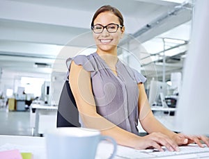 Im all about efficiency. an attractive young office worker sitting at her desk and working on a computer.
